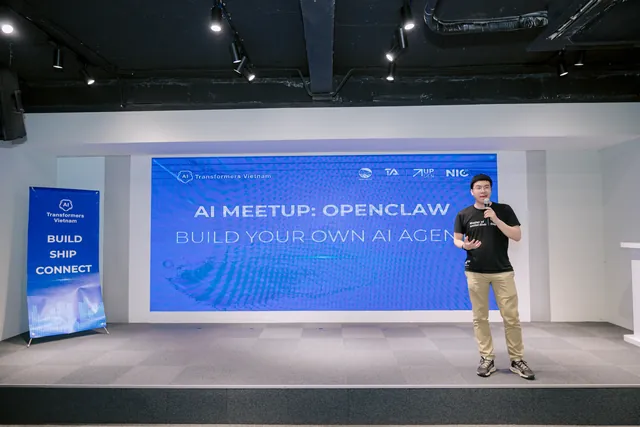 Daniel Nguyen speaking on stage at an AI meetup, the screen behind him reading Build your own AI agent