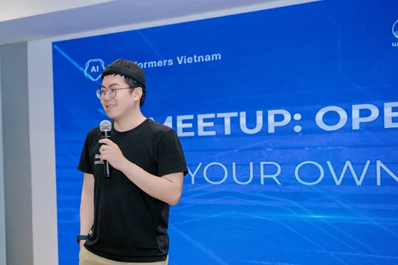 Daniel Nguyen speaking on stage with a microphone at an AI meetup