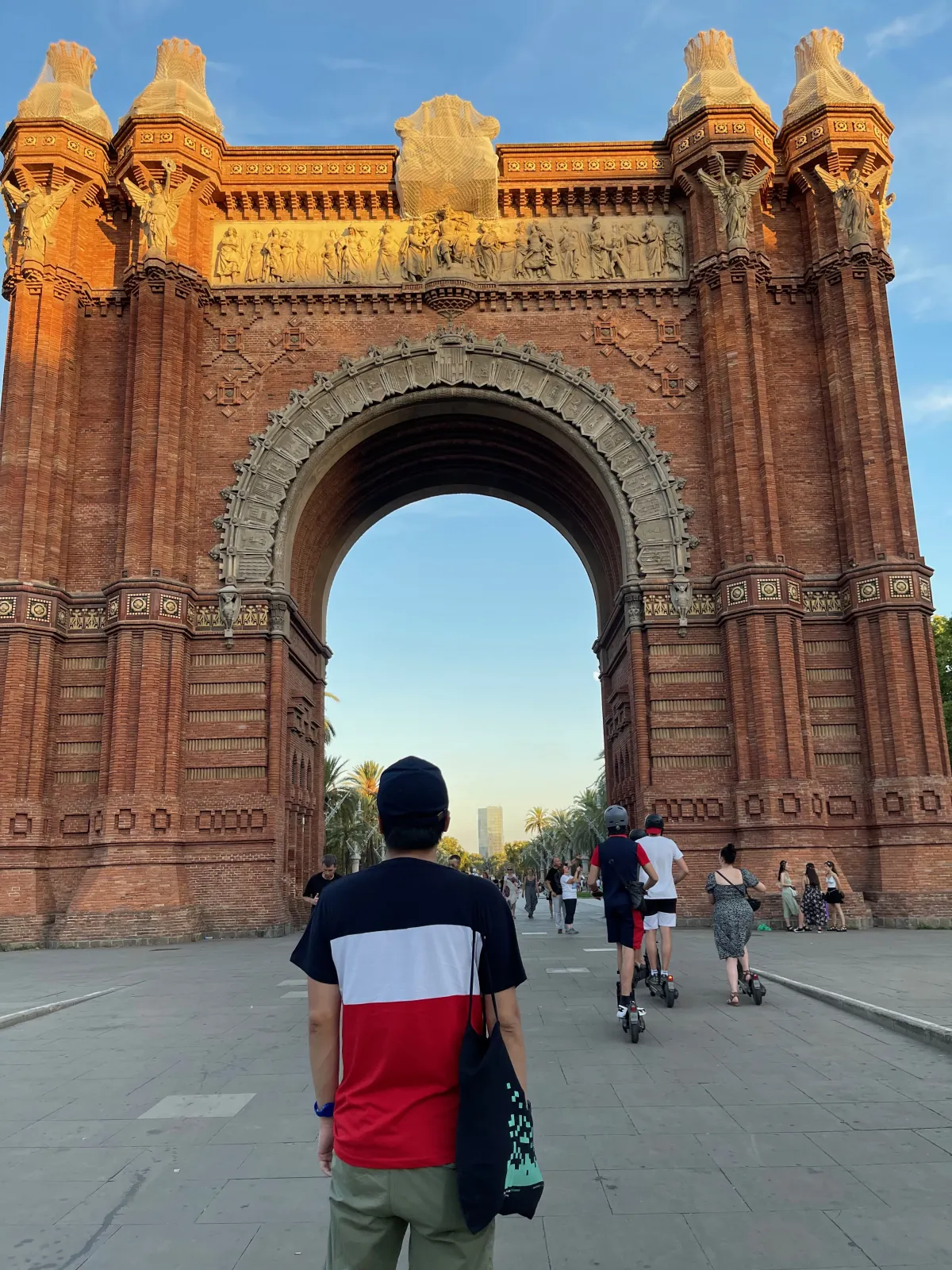 Daniel Nguyen walking toward the Arc de Triomf in Barcelona