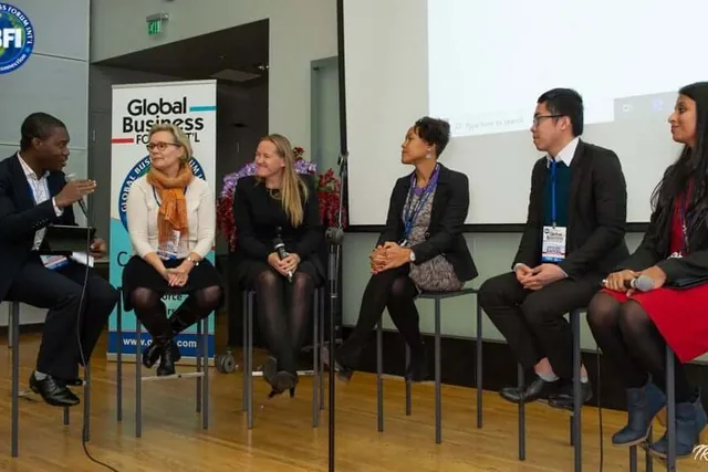 Six panellists seated on stools at Global Business Forum Finland, Daniel second from the right