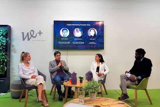 Four speakers on chairs at a digital marketing fireside chat, Daniel second from the left